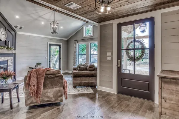 a living room with furniture and a floor to ceiling window