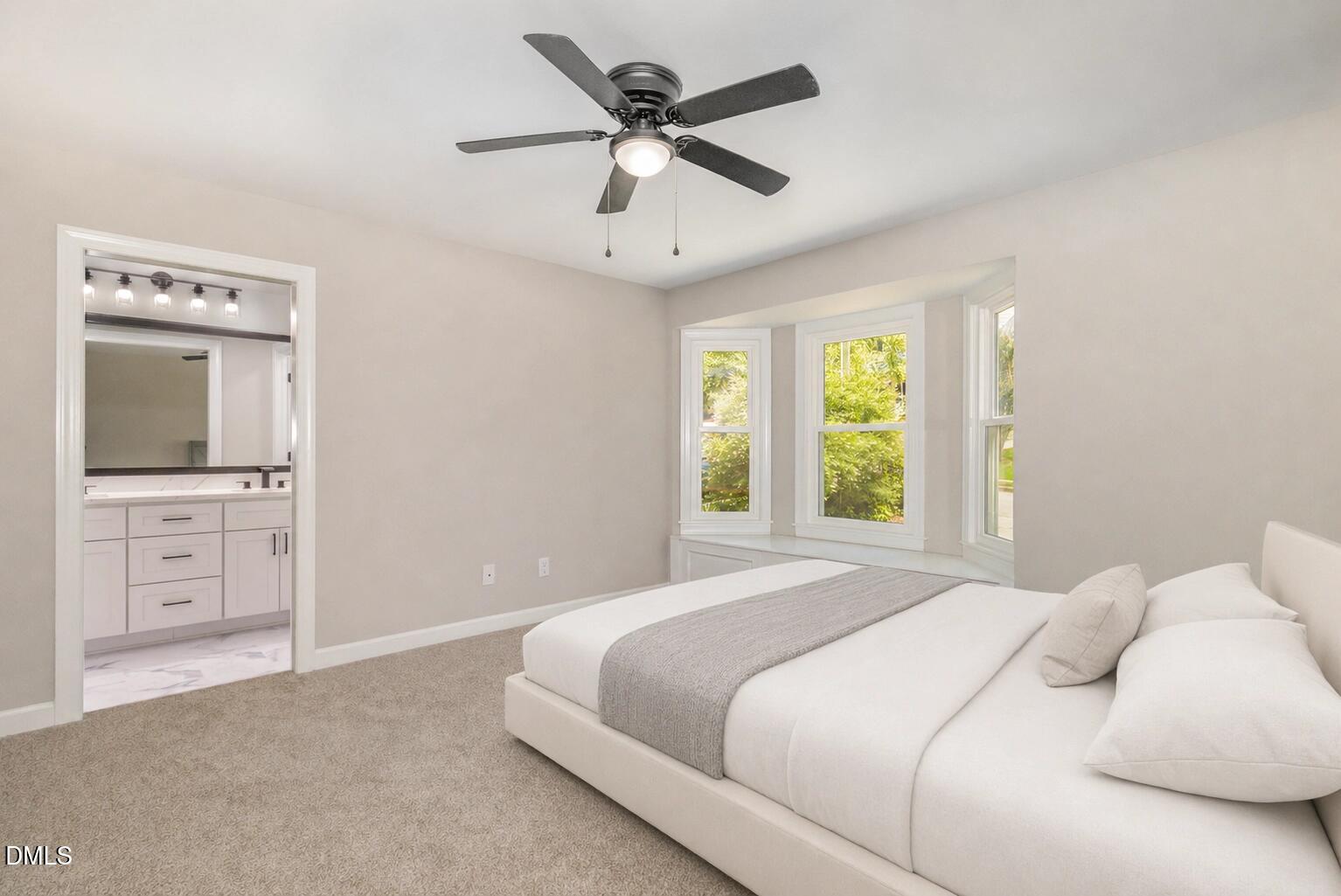 2324 Dahlgreen Road Raleigh, NC 27615 - Photo 12 of 21 a bedroom with a large bed and a flat tv screen on dresser