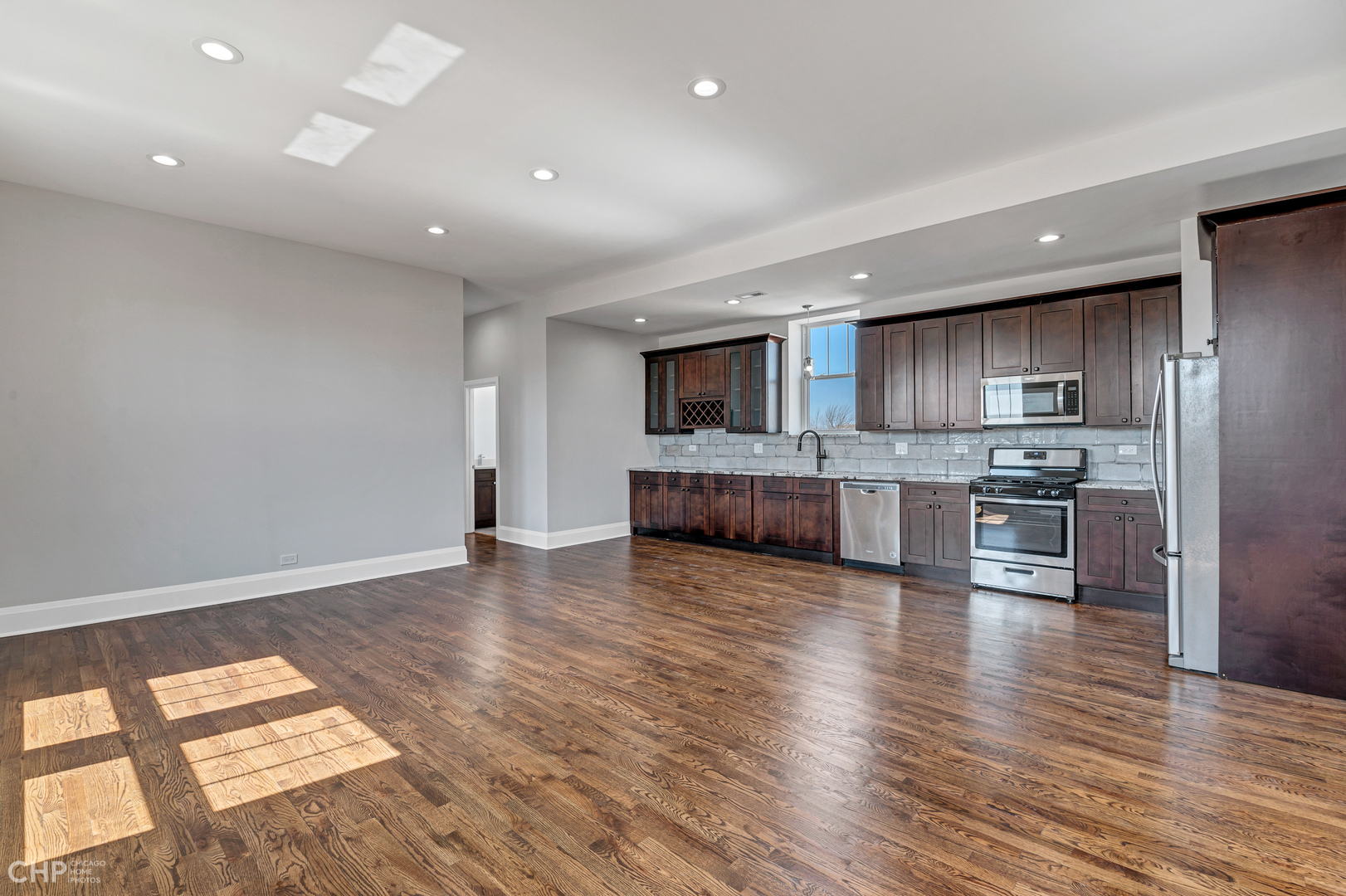 2100 North Halsted Street, Unit 4R Chicago, IL 60614 - Photo 2 of 26 a large kitchen with stainless steel appliances granite countertop a stove a sink and a refrigerator