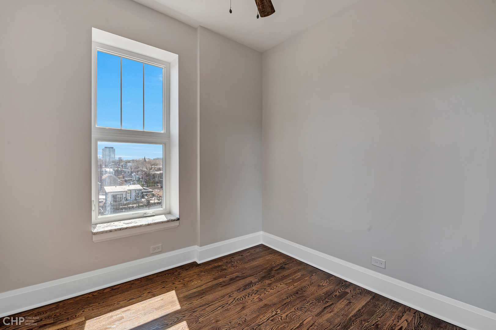 2100 North Halsted Street, Unit 4R Chicago, IL 60614 - Photo 17 of 26 a view of an empty room with wooden floor and a window