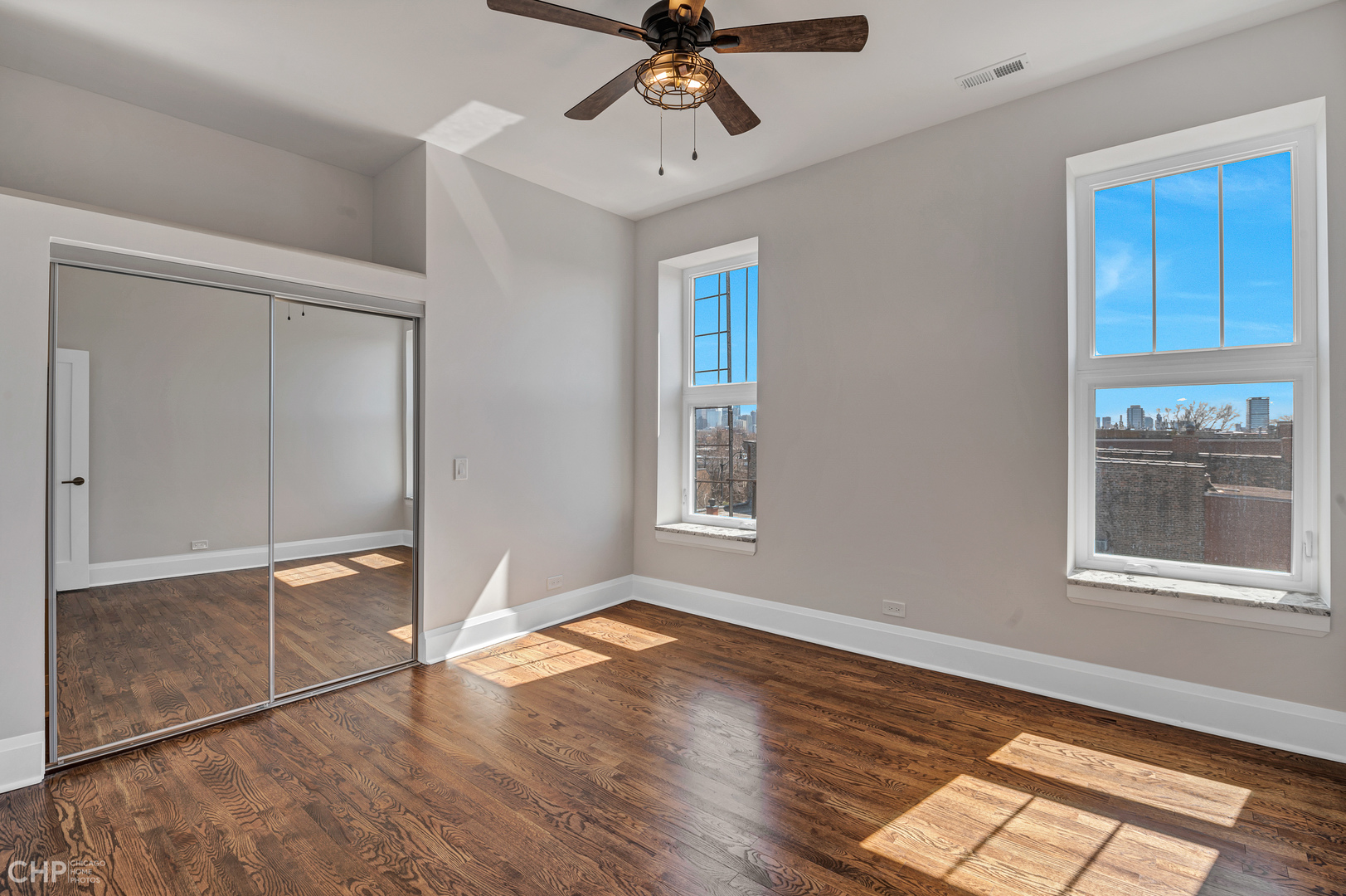 2100 North Halsted Street, Unit 4R Chicago, IL 60614 - Photo 19 of 26 a view of empty room with wooden floor and fan
