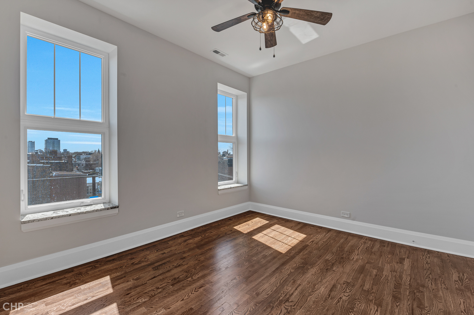 2100 North Halsted Street, Unit 4R Chicago, IL 60614 - Photo 20 of 26 a view of empty room with wooden floor and fan