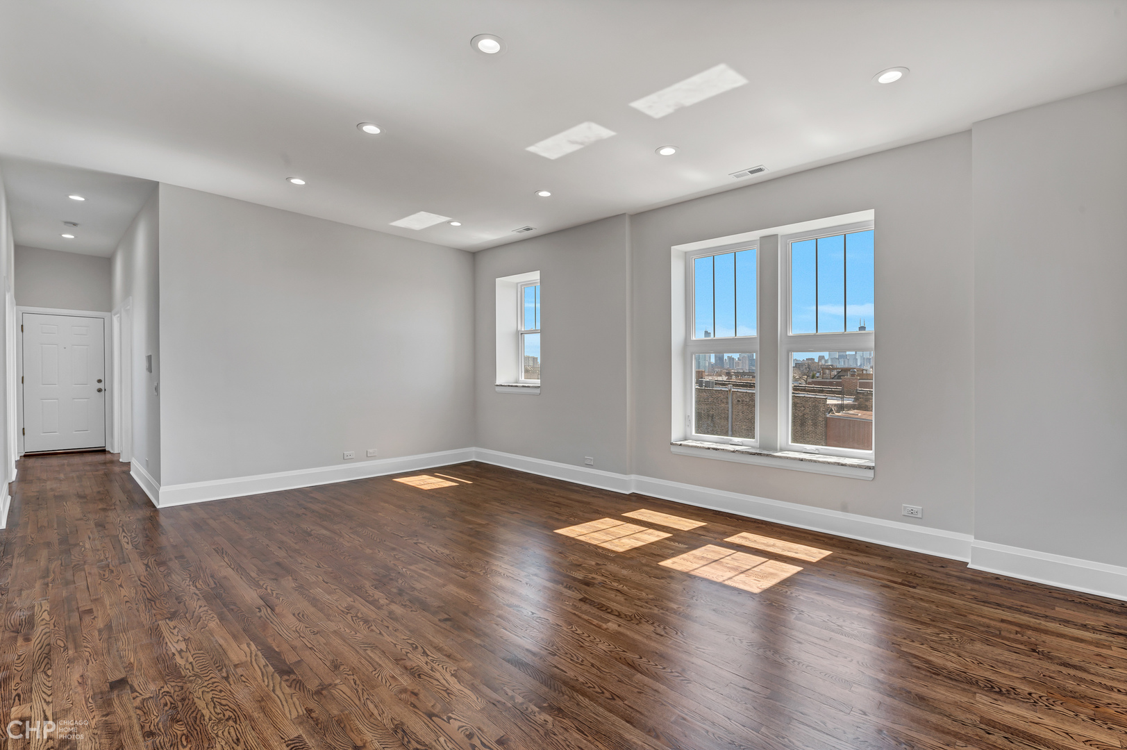 2100 North Halsted Street, Unit 4R Chicago, IL 60614 - Photo 4 of 26 a view of an empty room with wooden floor and a window