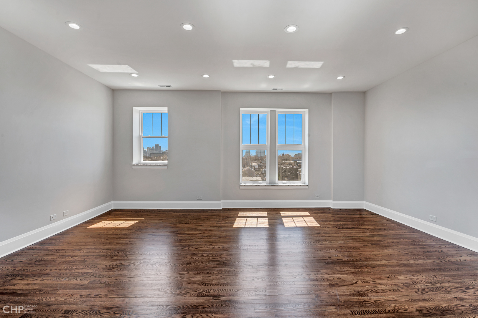2100 North Halsted Street, Unit 4R Chicago, IL 60614 - Photo 5 of 26 an empty room with wooden floor and windows
