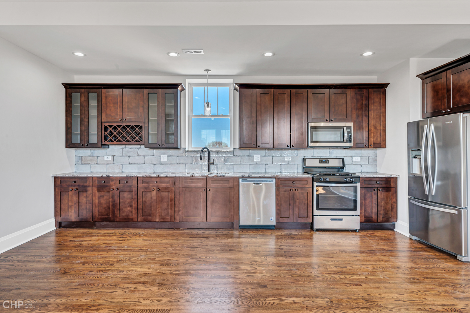 2100 North Halsted Street, Unit 4R Chicago, IL 60614 - Photo 7 of 26 a kitchen with granite countertop a refrigerator and a stove top oven