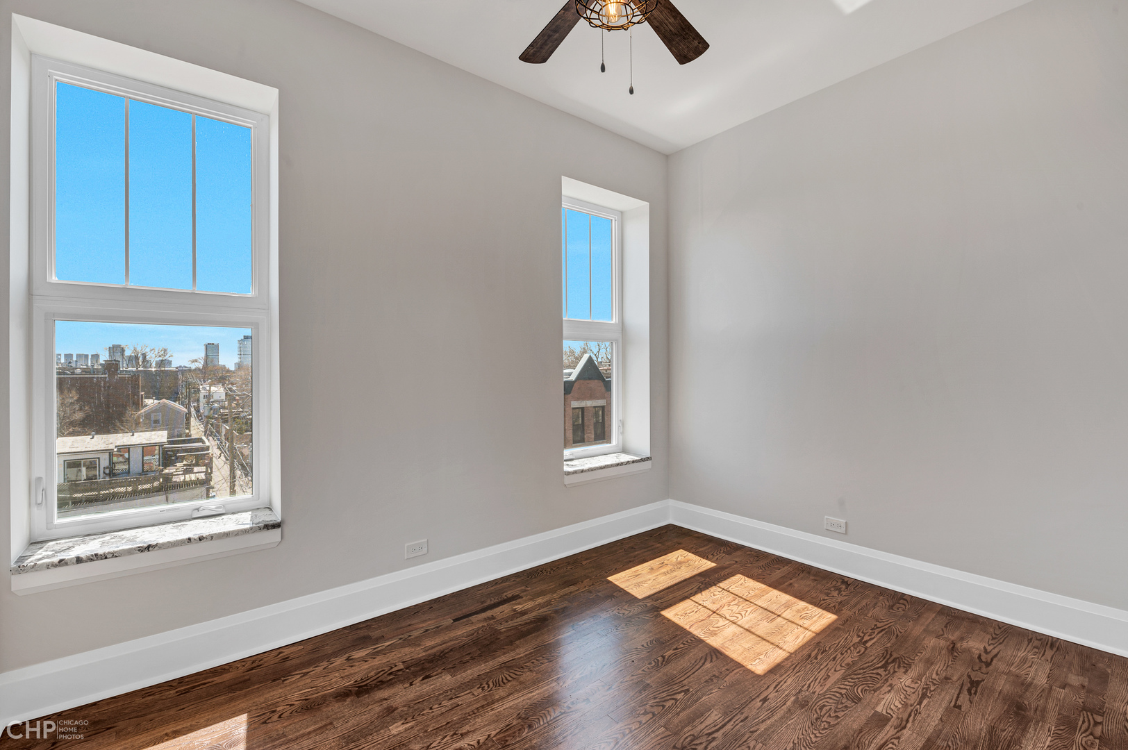2100 North Halsted Street, Unit 4R Chicago, IL 60614 - Photo 9 of 26 an empty room with wooden floor and windows