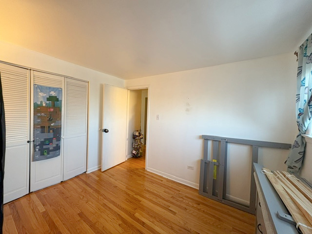 3925 West 47th Street, Unit 3N Chicago, IL 60632 - Photo 12 of 14 a view of a room with wooden floor and bedroom