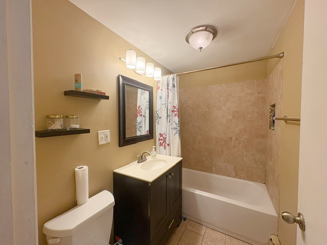 3925 West 47th Street, Unit 3N Chicago, IL 60632 - Photo 13 of 14 a bathroom with a sink mirror vanity and toilet