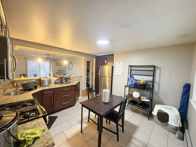 a view of a dining room with furniture and a window