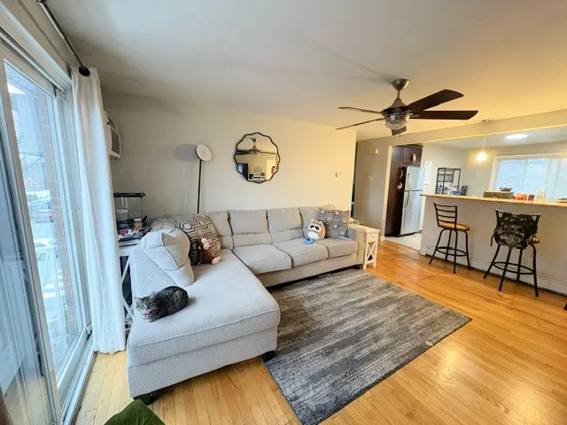 a living room with furniture and kitchen view
