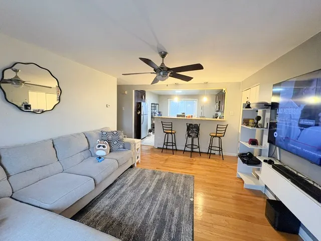 a living room with furniture and kitchen view