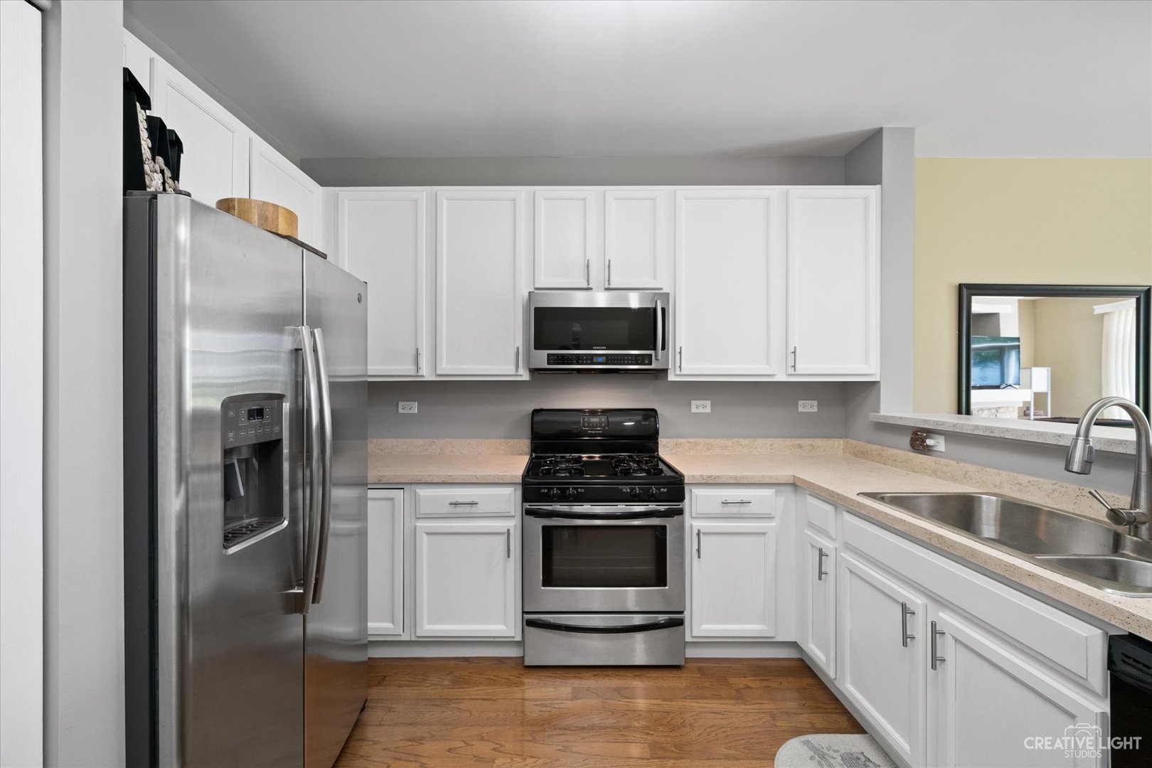 2408 Oneida Lane Naperville, IL 60563 - Photo 6 of 17 a kitchen with white cabinets and stainless steel appliances