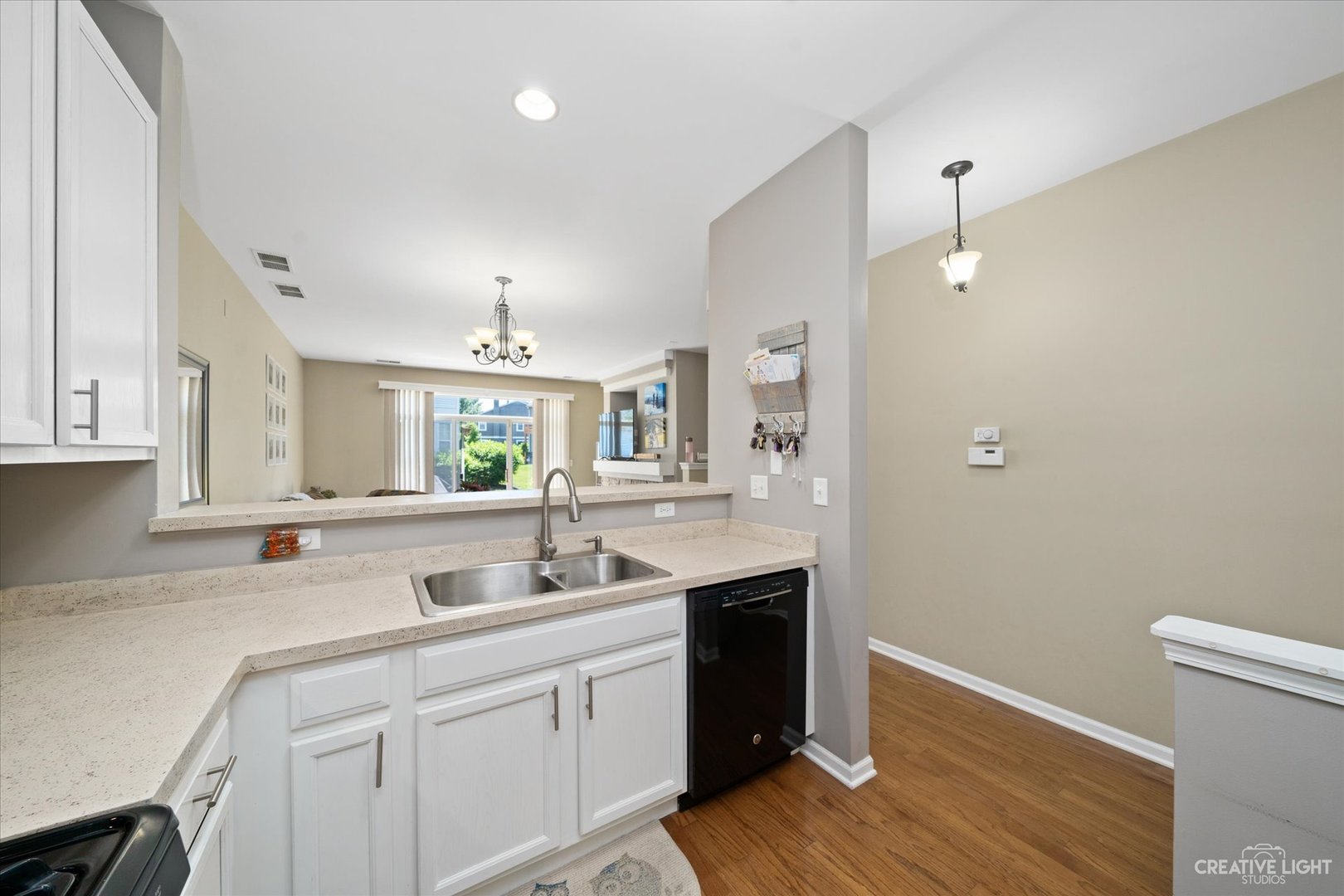 2408 Oneida Lane Naperville, IL 60563 - Photo 7 of 17 a kitchen with a sink cabinets and wooden floor