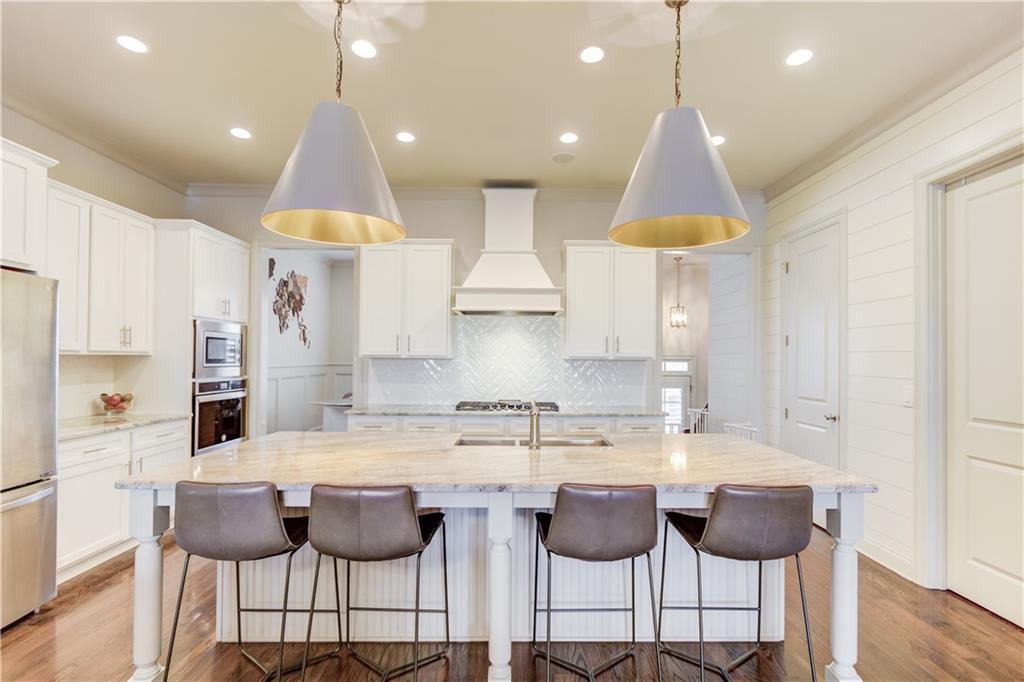 a kitchen with cabinets and chairs