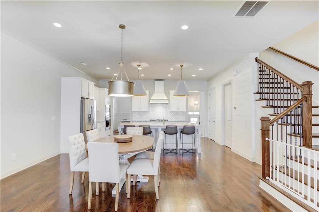 1816 Falling Sky Court Brookhaven, GA 30319 - Photo 11 of 44 a view of a dining room and livingroom with furniture wooden floor kitchen chandelier