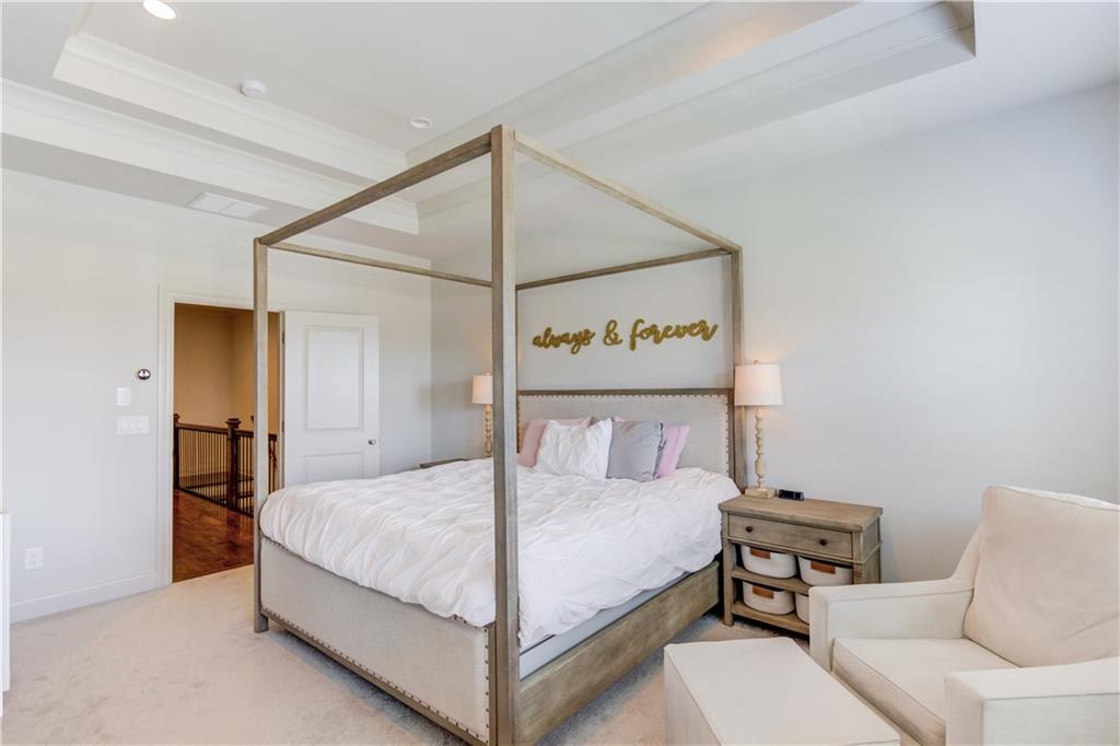 1816 Falling Sky Court Brookhaven, GA 30319 - Photo 18 of 44 a bedroom with a bed and a table