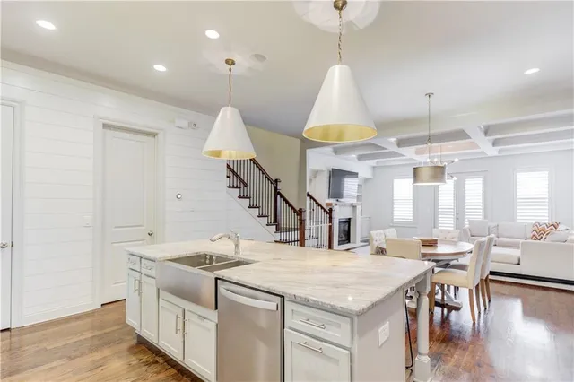 a kitchen with stainless steel appliances kitchen island granite countertop a stove a island a dining table and chairs