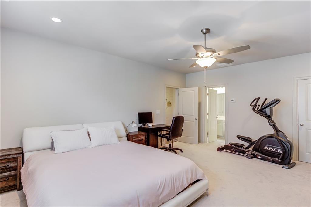 1816 Falling Sky Court Brookhaven, GA 30319 - Photo 32 of 44 a bedroom with a bed and a gym equipment