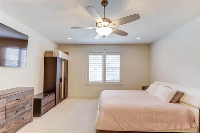 a bedroom with a large bed and a chandelier