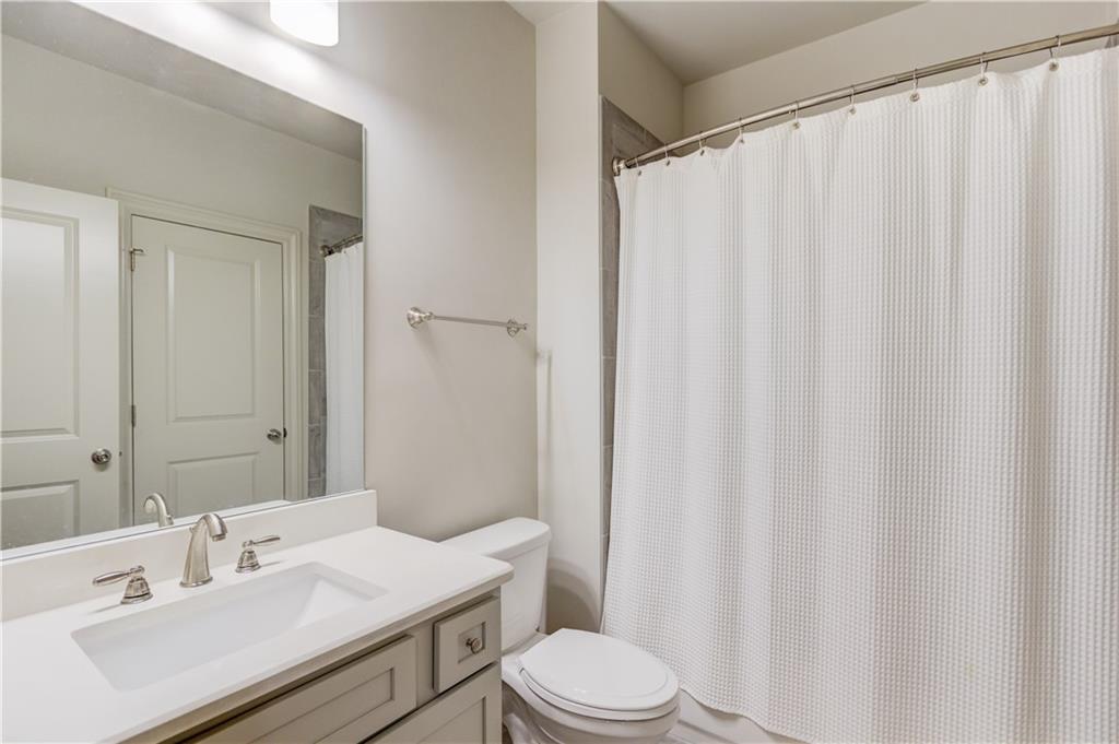 1816 Falling Sky Court Brookhaven, GA 30319 - Photo 34 of 44 a bathroom with a sink a toilet and shower curtain