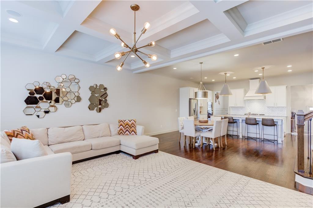 1816 Falling Sky Court Brookhaven, GA 30319 - Photo 4 of 44 a living room with lots of furniture and a chandelier