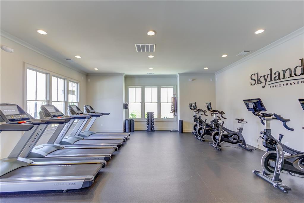 1816 Falling Sky Court Brookhaven, GA 30319 - Photo 41 of 44 a living room with furniture gym equipment and a large window