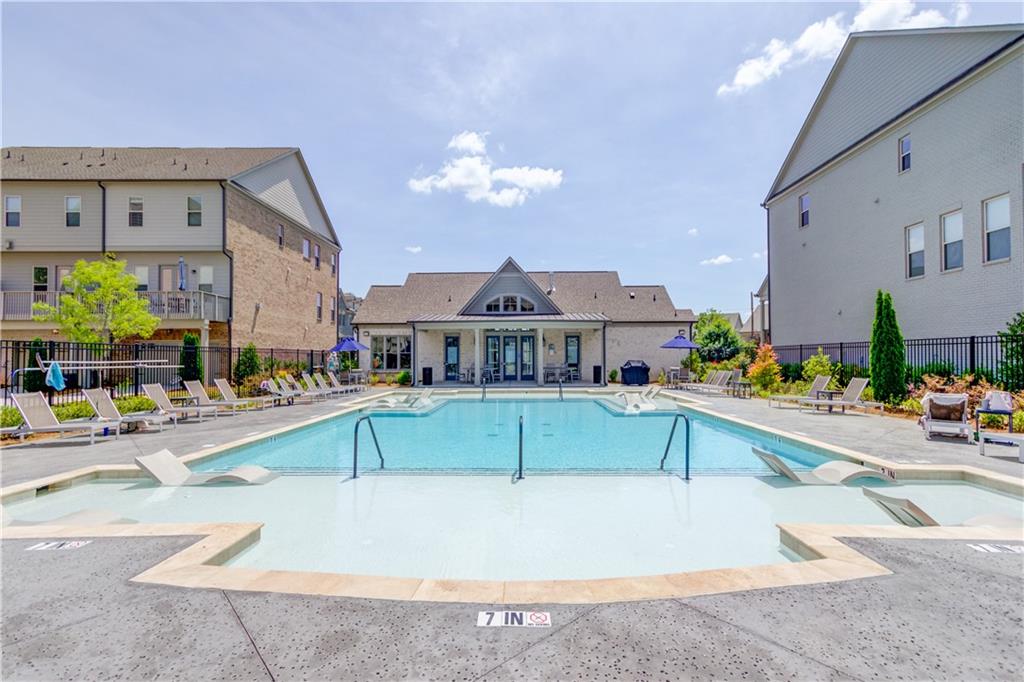 1816 Falling Sky Court Brookhaven, GA 30319 - Photo 42 of 44 a view of a swimming pool with a lounge chair