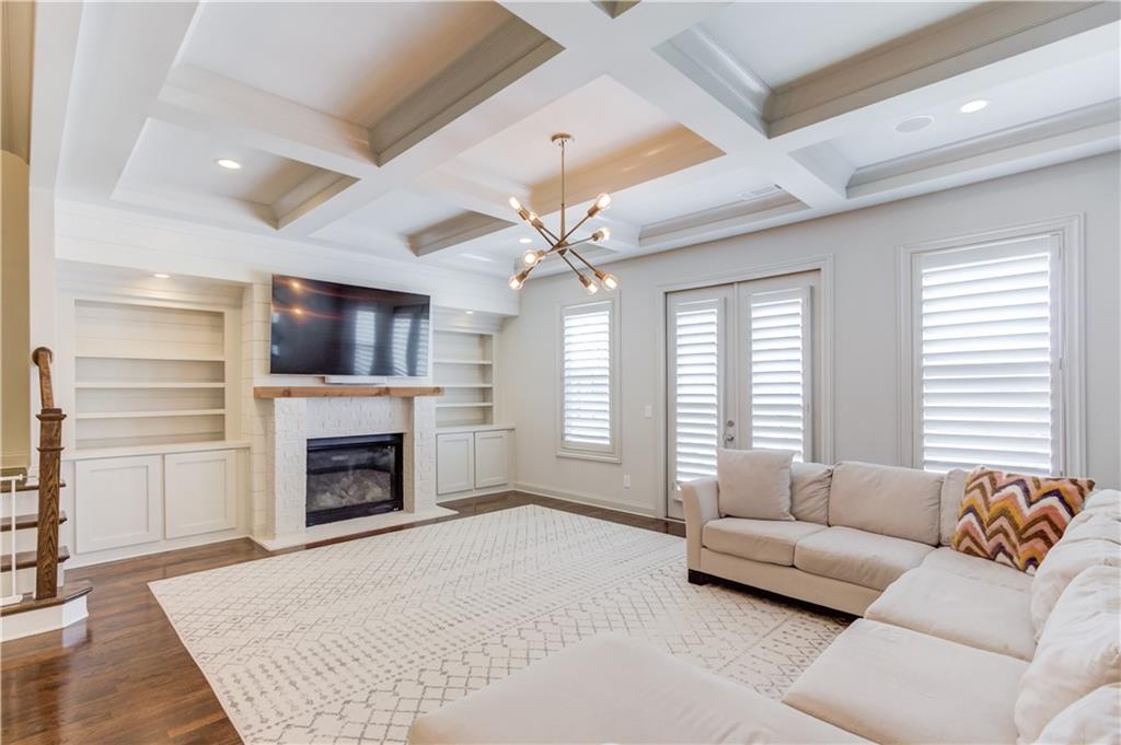 1816 Falling Sky Court Brookhaven, GA 30319 - Photo 7 of 44 a living room with furniture a flat screen tv and a fireplace