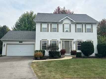 a view of a house with a yard and plants