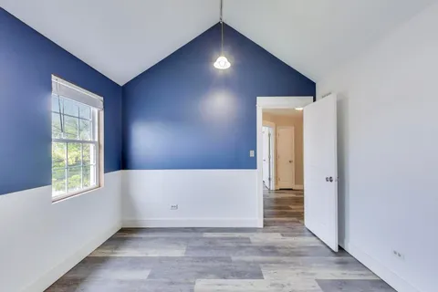 an empty room with windows and closet