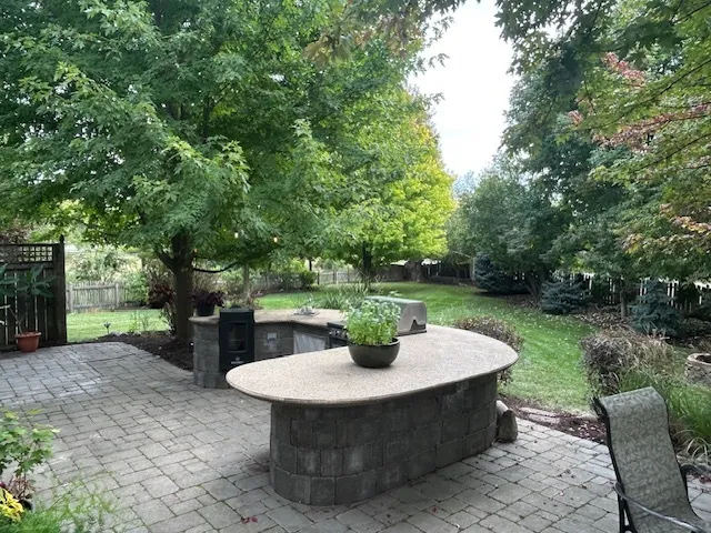 a view of a table and chairs in a backyard