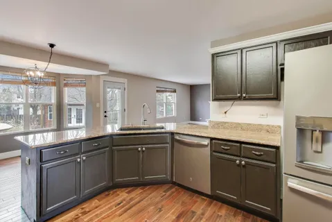 a kitchen with a sink stove and cabinets