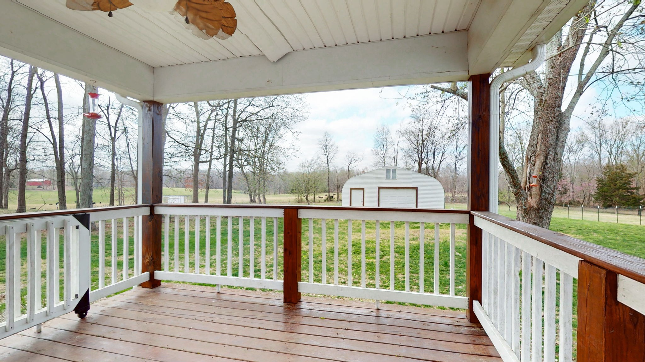 7563 South Swift Road Goodlettsville, TN 37072 - Photo 16 of 25 a view of a porch with wooden floor and iron stairs