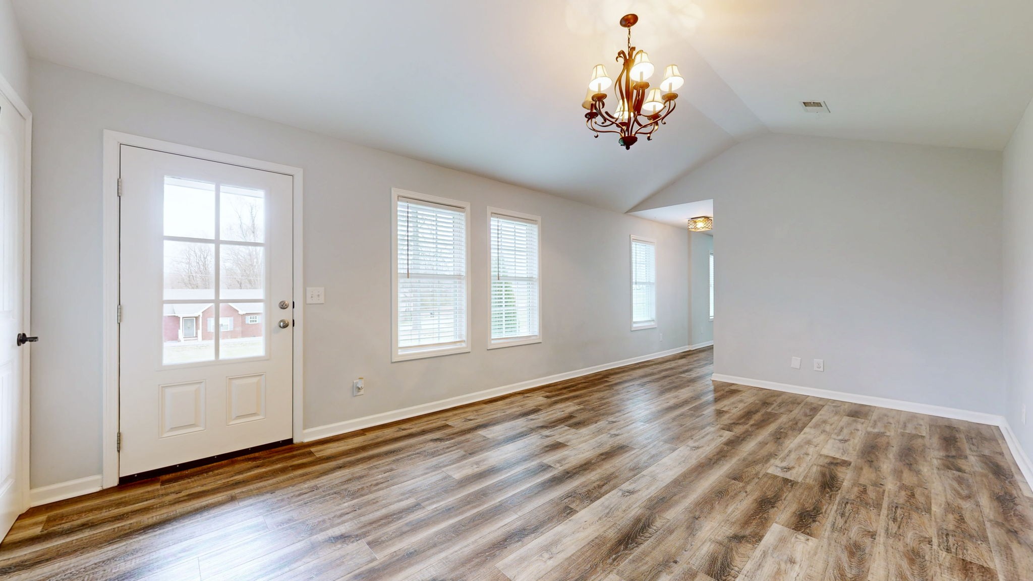 7563 South Swift Road Goodlettsville, TN 37072 - Photo 2 of 25 an empty room with wooden floor chandelier and windows