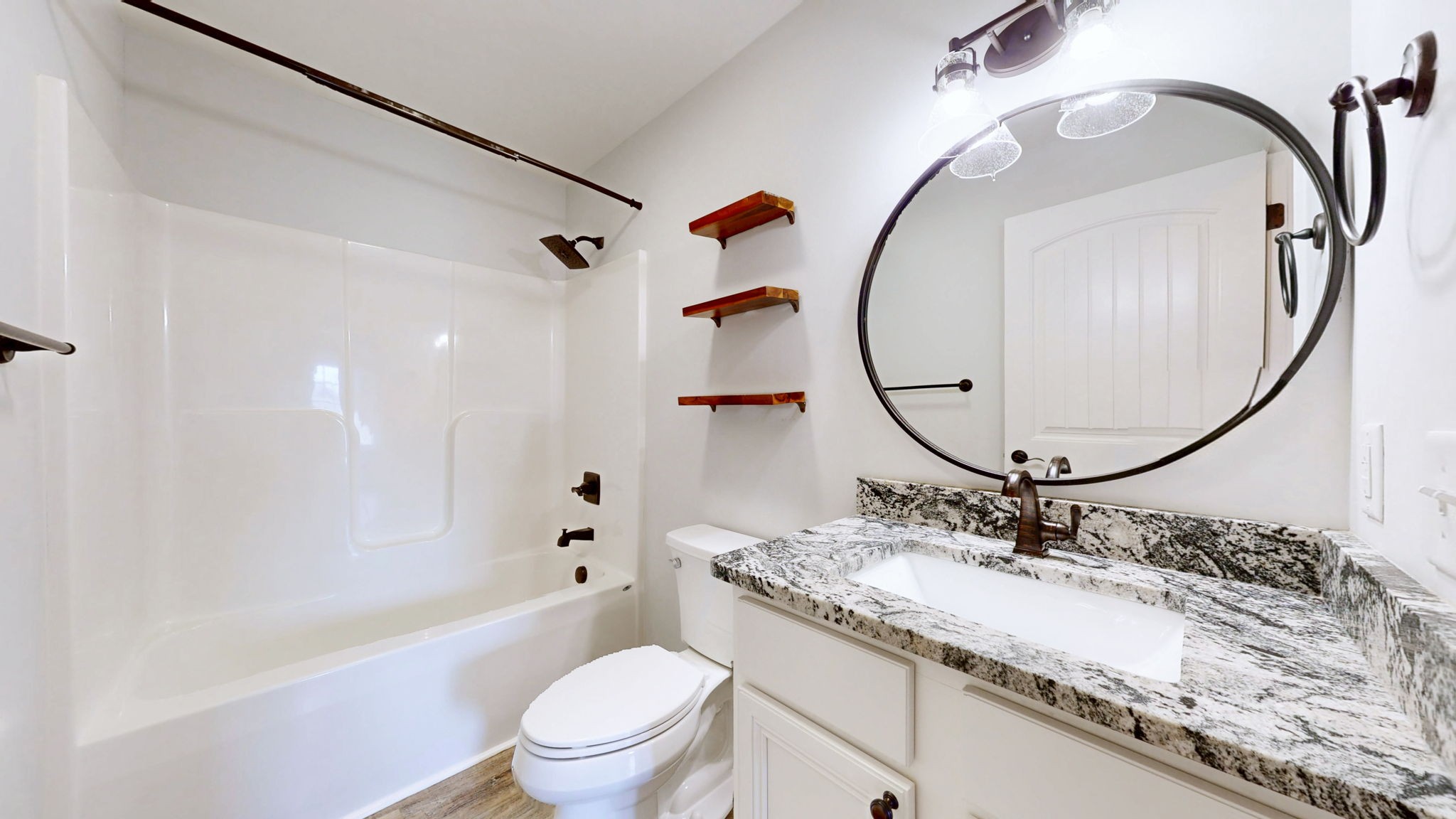 7563 South Swift Road Goodlettsville, TN 37072 - Photo 8 of 25 a bathroom with a granite countertop sink a mirror a toilet and a shower