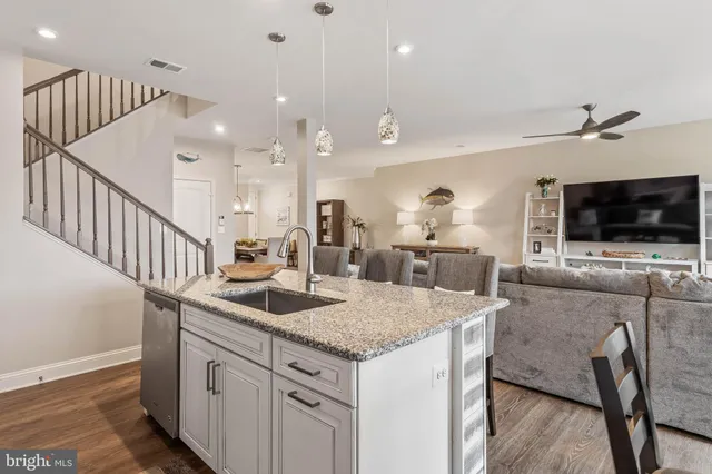 a kitchen with granite countertop a sink a counter top space appliances and cabinets