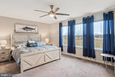 a bedroom with a large bed and a large window