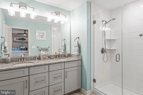 a bathroom with a granite countertop shower