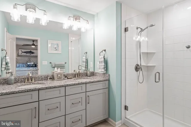 a bathroom with a granite countertop shower