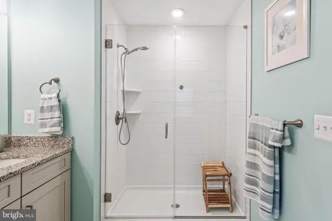 a bedroom with a large bed couch and a window