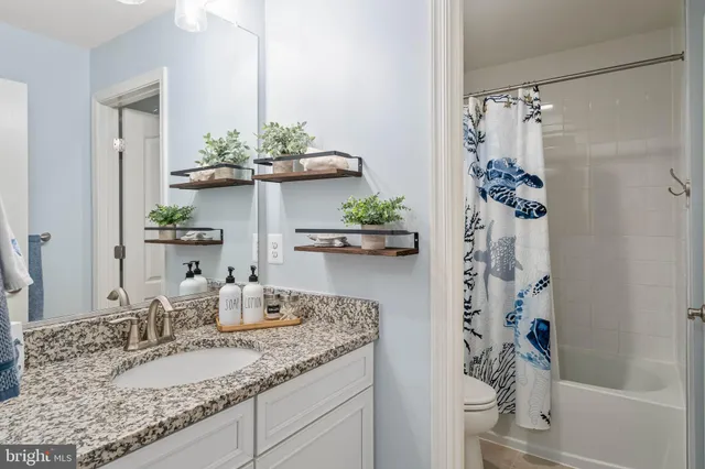 a bedroom with a bed couch and window