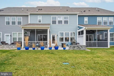 a view of a patio with couches chairs and potted plants