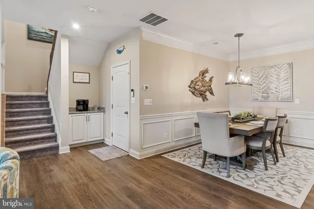 a view of a dining room with furniture wooden floor and chandelier