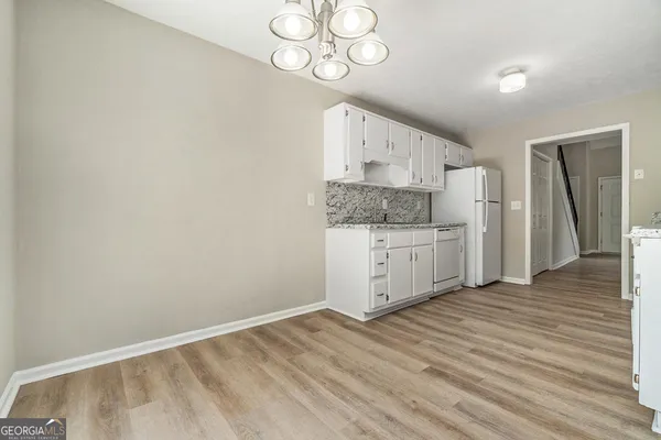 a view of a kitchen with wooden floor