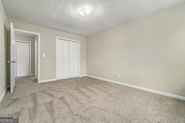 a view of an empty room and closet area