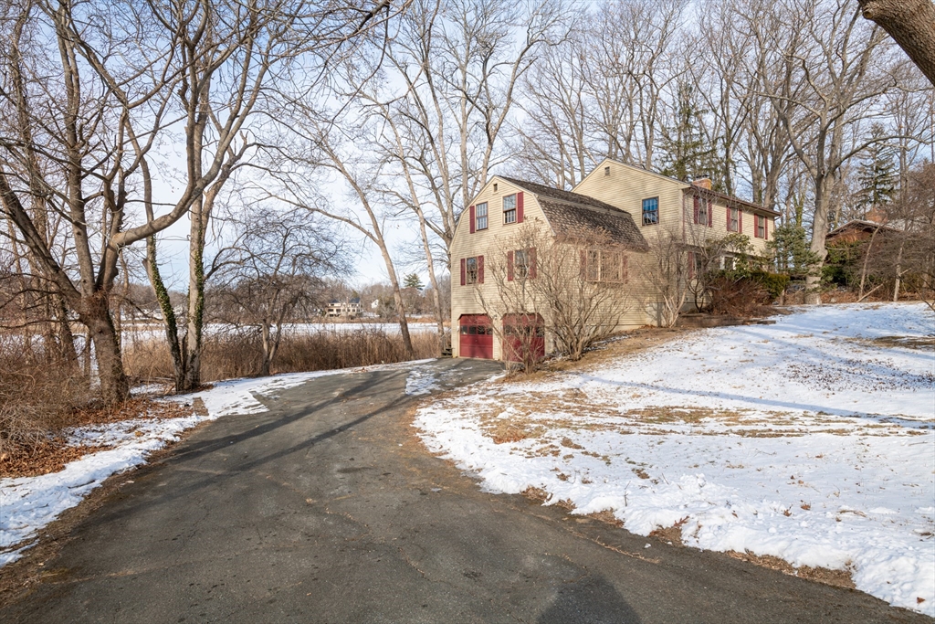 4 Riverside Drive Ipswich, MA 01938 - Photo 3 of 41 a view of a yard with a snow on the road