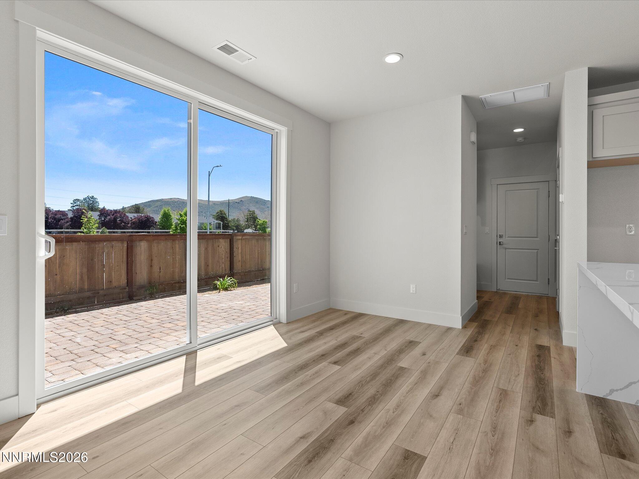 1383 Vine Gate Road, Unit HOMESITE 51 Carson City, NV 89701 - Photo 6 of 20 wooden floor in an empty room with a glass door