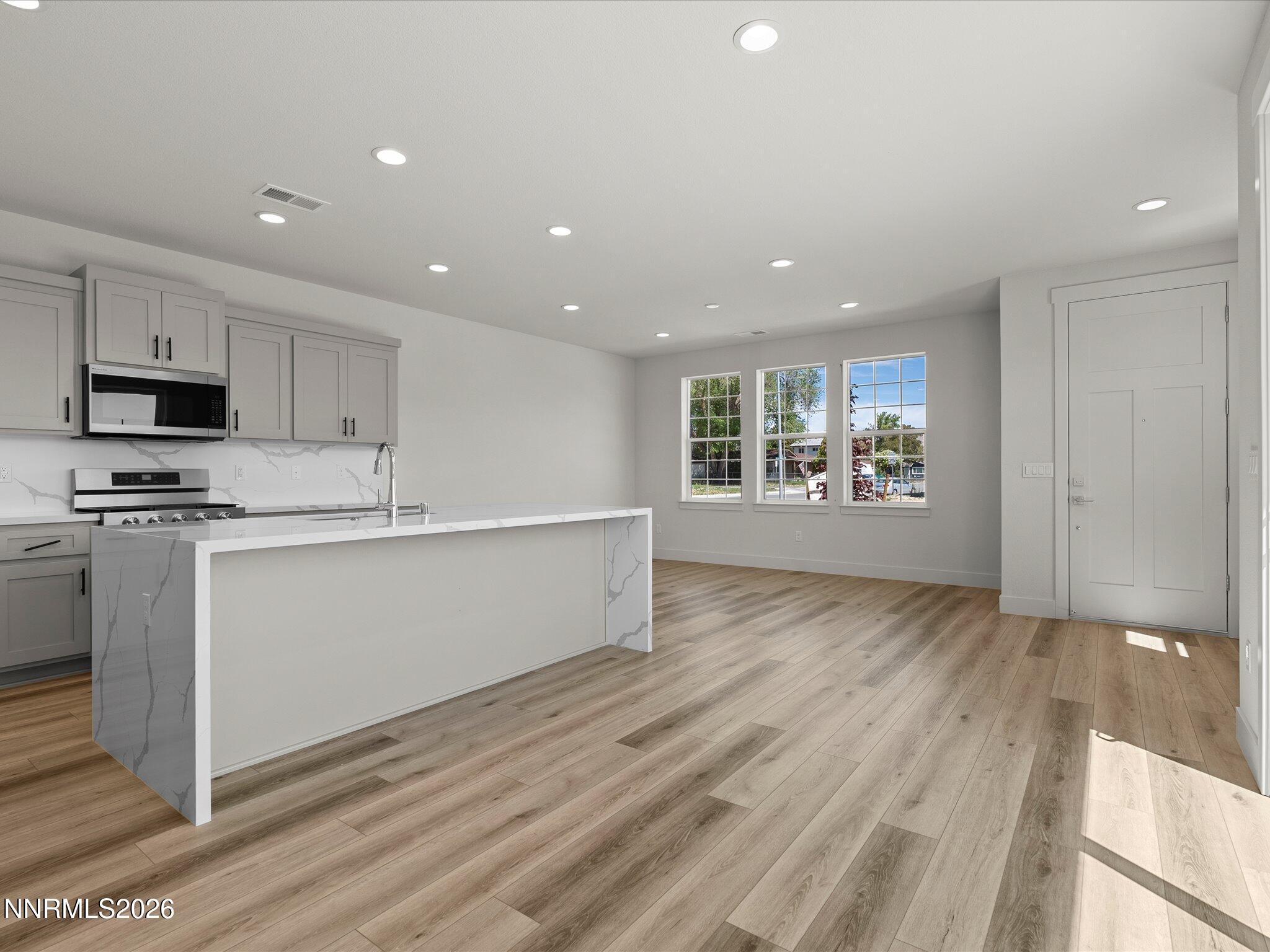 1383 Vine Gate Road, Unit HOMESITE 51 Carson City, NV 89701 - Photo 8 of 20 a view of kitchen with granite countertop cabinets and wooden floor
