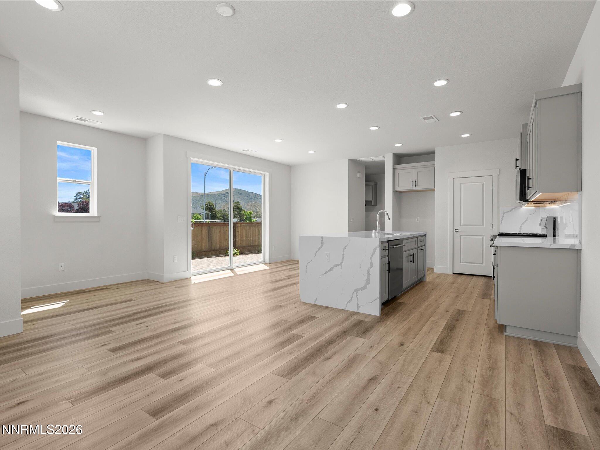 1383 Vine Gate Road, Unit HOMESITE 51 Carson City, NV 89701 - Photo 9 of 20 a large kitchen with stainless steel appliances granite countertop a large counter top and a wooden floor