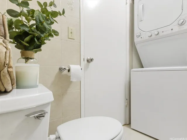 a white toilet sitting next to a bathroom sink